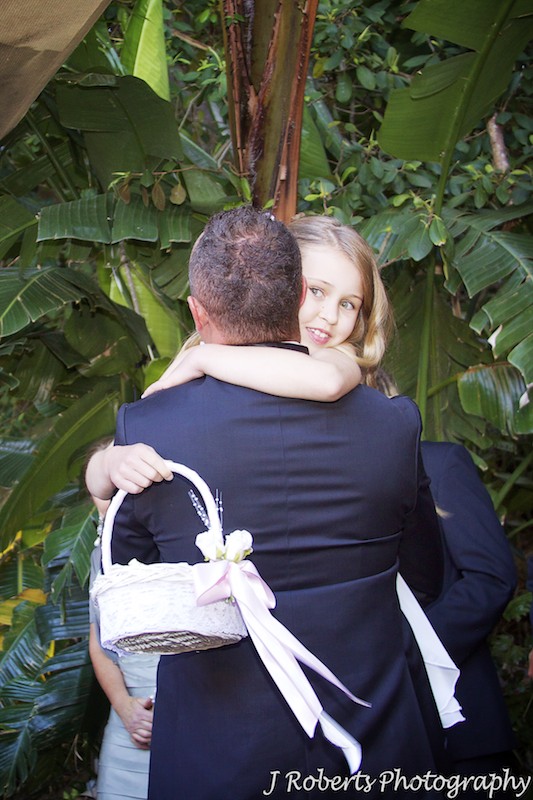 Daughter hugging groom after wedding ceremony - wedding photography sydney